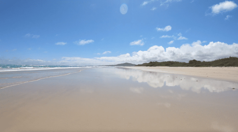 Relaxing beach landscape with gentle ocean waves during a December Galapagos cruise experience with Cruises to Galapagos Islands