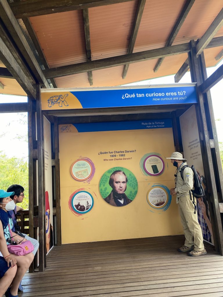 Charles Darwin Station exhibit with tourists and a guide learning about conservation during our agency’s Galápagos cruise tour