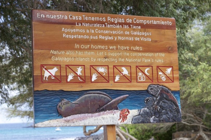 Galápagos National Park behavior rules sign promoting responsible tourism and wildlife conservation during our agency’s cruise tour