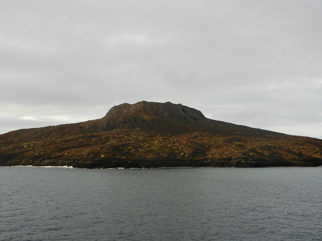 Scenic view of Sombrero Chino Island under cloudy skies during an October adventure with Cruises to Galapagos Islands