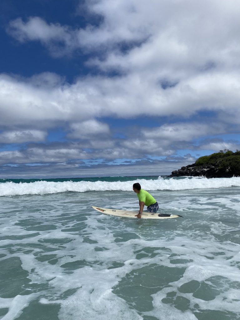 Tourist surfing in the Galapagos Islands during a March cruise adventure with Cruises to Galapagos Islands