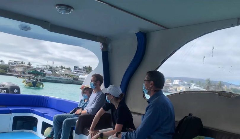Travelers seated aboard a small boat during a Galápagos cruise transfer, featured in our agency’s health and seasickness guide